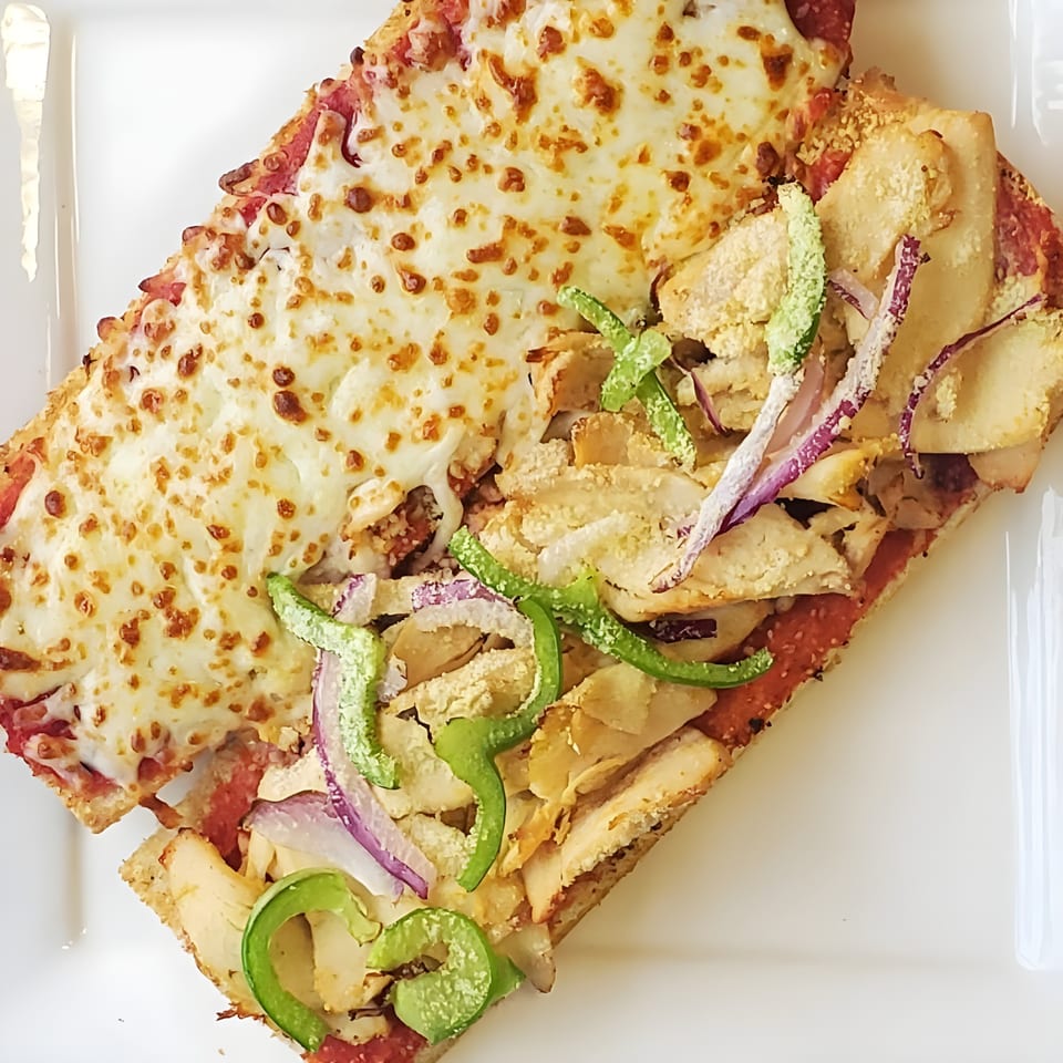 Mancino's of Taylor pizza with melted cheese, chicken, green peppers, and red onions.